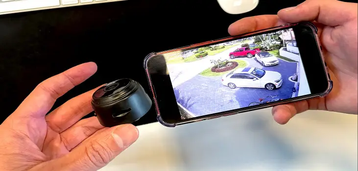 person holding PixieLens Pro with mobile